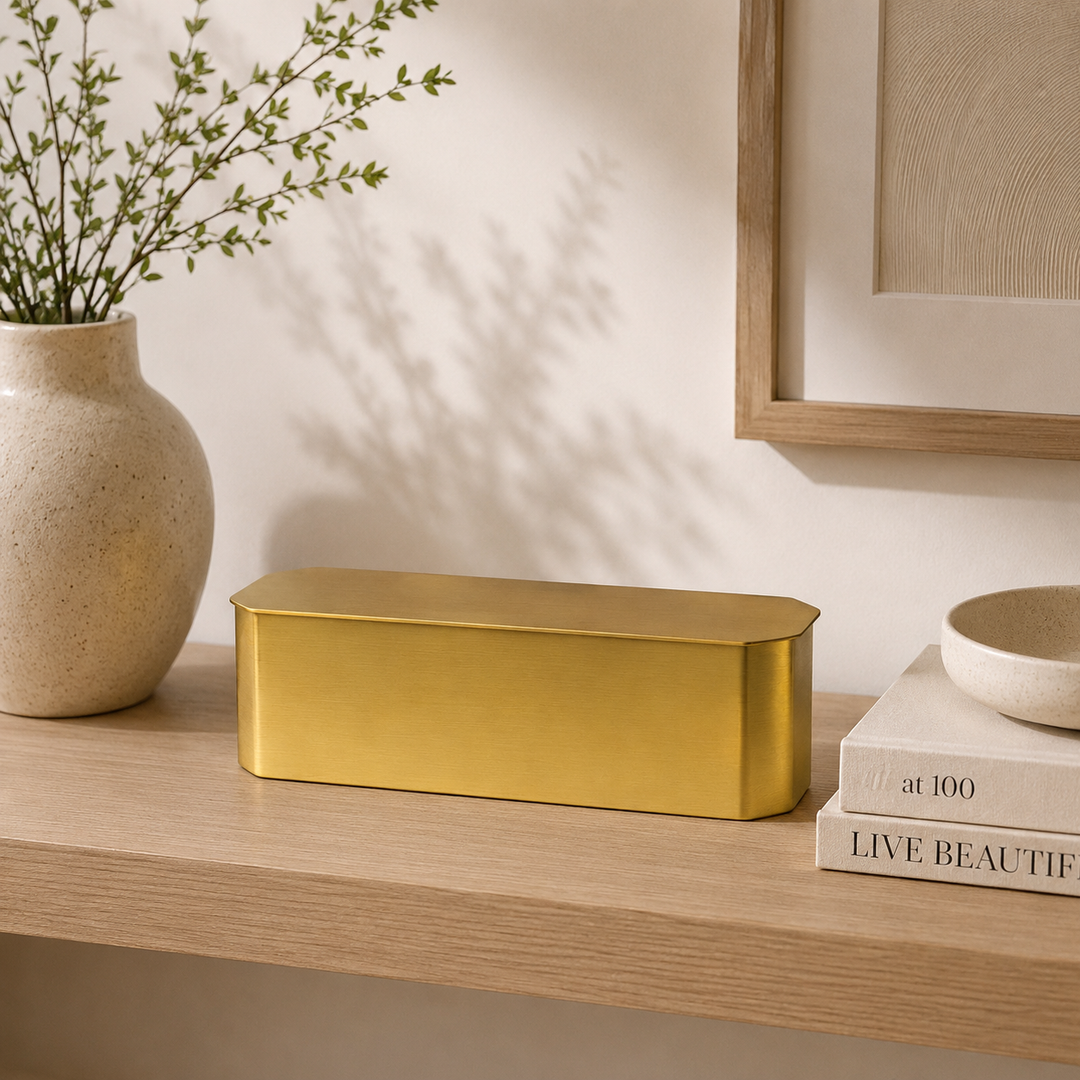 rectangular metallic gold box with a rounded lid sits